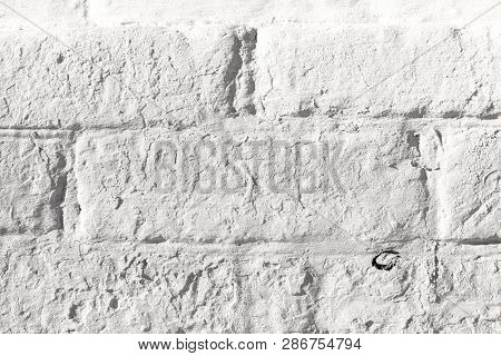 White Painted Old Brick Wall Texture. Bleached Rough Aged Brickwork. Niveous Light Background.