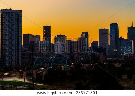 Golden Sunrise Over The Huge Cityscape Skyline Of Downtown Mile High City Of Denver Colorado Usa Wit