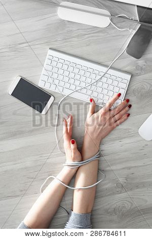Dependence On New Technologies.
A Woman With Bound Hands Writes On A Computer Keyboard.