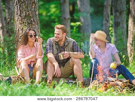 Camping And Hiking. Halt For Snack During Hiking. Company Friends Relaxing And Having Snack Picnic N