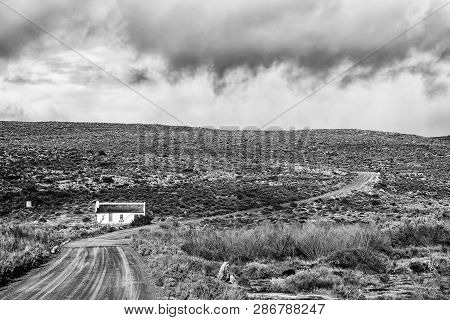 Matjiesrivier, South Africa, August 27, 2018: Landscape With An Historic House With Reed Roof At Mat