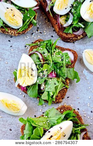 Healthy Fitness Toasts With Arugula And Egg. Useful Snack Lunch. Useful Vegetarian Toast. Open Sandw