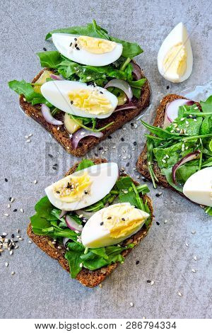 Healthy Fitness Toasts With Arugula And Egg. Useful Snack Lunch. Useful Vegetarian Toast. Open Sandw