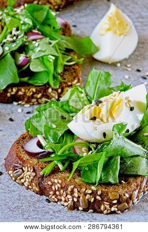 Healthy Fitness Toasts With Arugula And Egg. Useful Snack Lunch. Useful Vegetarian Toast. Open Sandw