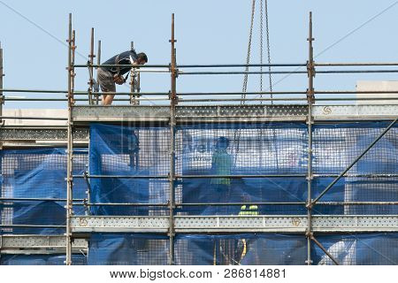Gosford, New South Wales, Australia - December 1, 2018: Construction Worker On New Home Units Buildi