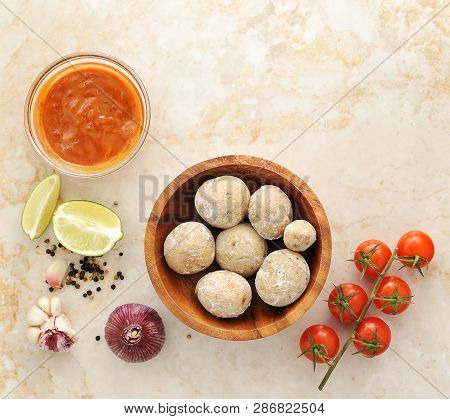 Canarian Potatoes - Boiled With Salt, Mojo Sauce, Lime, Tomato, Garlic And Spices On A Marble Backgr