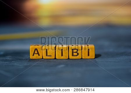 Alibi On Wooden Blocks. Cross Processed Image With Bokeh Background