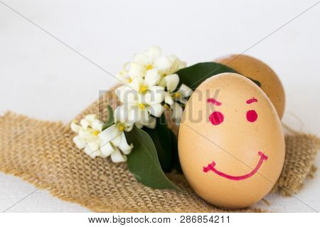 Happy Eggs Face Writing On Eggs Healthy Foods With Flower Jasmine And Sack Arrangement On Background