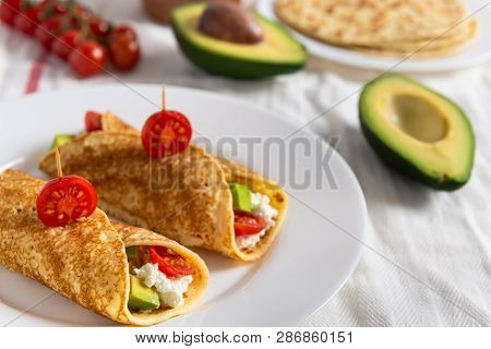 Crepe Pancakes With Avocado, Soft White Cheese And Cherry Tomatoes On White Plate. Cherry Tomatoes, 