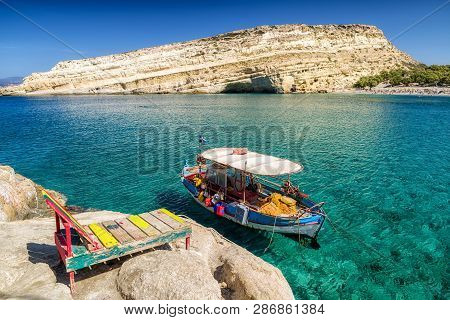 Matala, Crete - September 24: Crystal Clear Sea Amd Boat At Matala Beach On September 24, 2017 In Ma