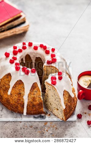 Sliced Lemon Poppy Seed Bundt Cake With Sugar Glaze And Redcurrant, Copy Space For Your Text