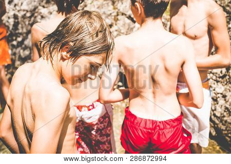 Young Boys Have Fun At The Small River - Outdoor Summer Activities - Fun In The Nature Concept
