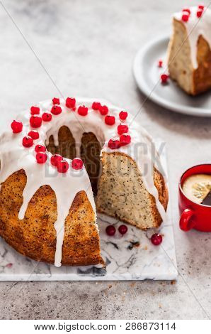 Sliced Lemon Poppy Seed Bundt Cake With Sugar Glaze And Redcurrant, Copy Space For Your Text
