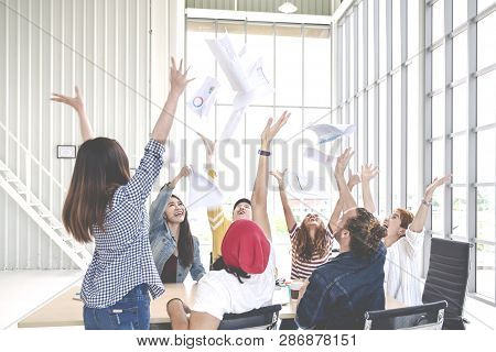 Candid Group Of Young Creative Team Employee Prople Throwing Documents Paper And Feeling Happy After