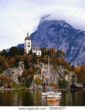 Beautiful Scenic Sunset Over Austrian Alps Lake. Boats, Yachts In The Sunlight Infront Of Church On 
