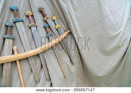 Medieval Weapons For Close Combat Displayed On Grey Fabric Texture