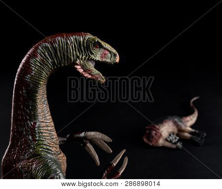 Nothronychus In Front Of A Dinosaur Body On Dark Background