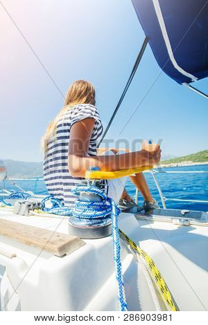 Girl On Board Of Sailing Yacht On Summer Cruise. Travel Adventure, Yachting With Child On Family Vac