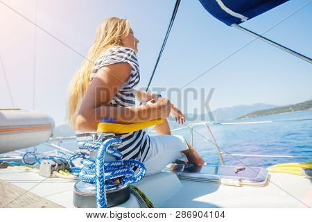Girl On Board Of Sailing Yacht On Summer Cruise. Travel Adventure, Yachting With Child On Family Vac