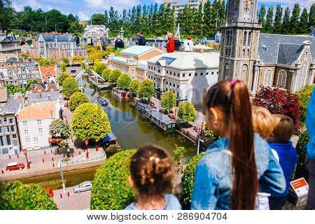 Netherlands. Den Haag. Miniature Park Madurodam.july 2016. Girls Look At The Water And The City In M