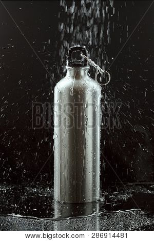 Aluminium Water Flask On Reflective Black Surface