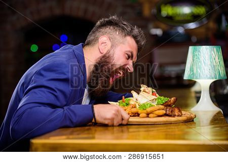 Cheat Meal Concept. Hipster Hungry Eat Pub Fried Food. Manager Formal Suit Sit At Bar Counter. Delic