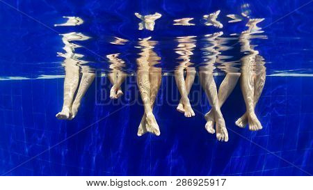 3 Generation Of Happy Family Has Fun, Relax At Poolside. Underwater Photo Of Bare Feet In Swimming P