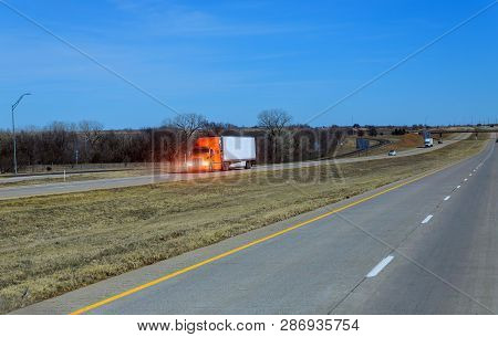 Car Driving On The Highway In The Background In A Transcontinental Highway In The United States