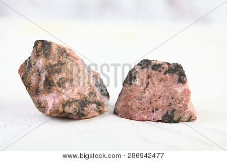 Natural Mineral Rock Specimen - Rough Rhodonite Stone From M. Sidelnikovo, Ural, Russia On White Cem