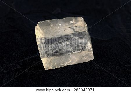 Raw Iceland Spar From Krasnoyarsk Region, Russia On Black Cement Background.