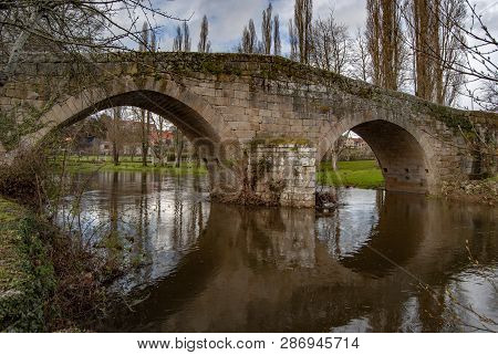 Old Bridge Above The City River, Arnoia, In The Medieval Town Of Allariz, Spain