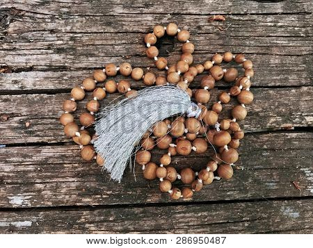 Rosary Beads On The Wooden Background. Rudraksha Mala For Mantras. 108 Beads.