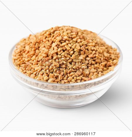 Bowl With Brown Aromatic Fenugreek Seeds Isolated On White Background