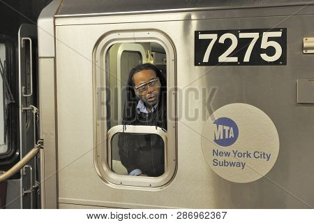 New York, Usa-november 11, 2012: A Subway Driver In New York City Looks Back To Check On Riders.