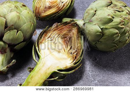 Artichokes On Rustic Background. Fresh Organic Artichoke Flower Set