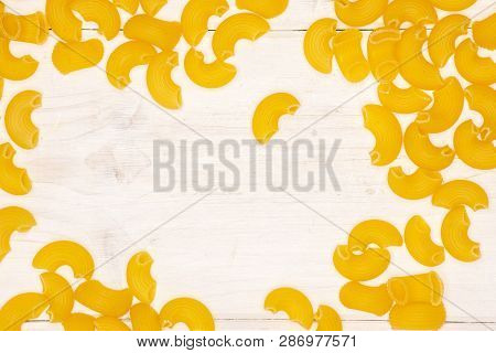 Lot Of Whole Raw Pasta Pipe Rigate Variety With Copyspace Flatlay On White Wood