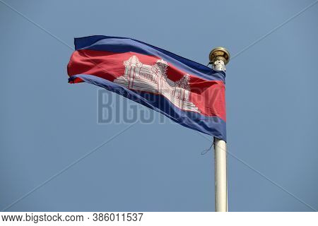 National Flag Of Cambodia On Bright Blue Sky Background. Blown Away By Wind. Cambodia Is One Of The 