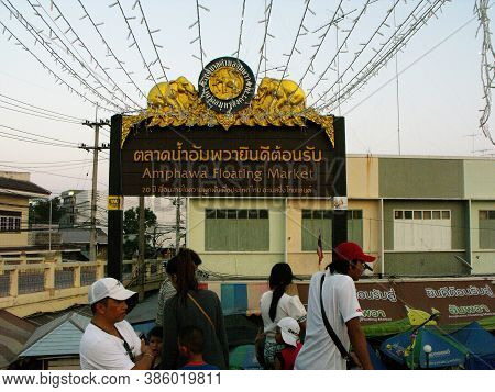 Amphawa, Thailand, January 23, 2016: Tourists Under A Sign On One Of The Bridges Across The Canal Of