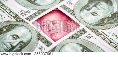 Yuan Banknote, Surrounded By 100 Dollar Bills. American Market Protectionism Concept