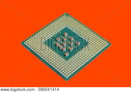 Photo Of A Cpu Chip Isolated On An Orange Background. Microprocessor, Central Processing Unit. Compu