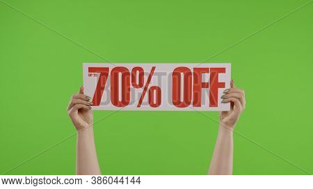 70 Percent Off Advertisement Inscription On Paper Sheet In Womans Hands On Green Screen. Holiday Dis