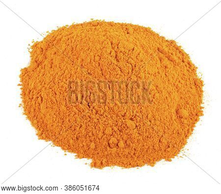 Close Up Of Heap Of Tumeric Powder Against A Plain White Isolated Background