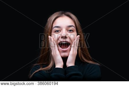 Surprised Happy Beautiful Woman Looking Sideways In Excitement, Isolated On Black Background