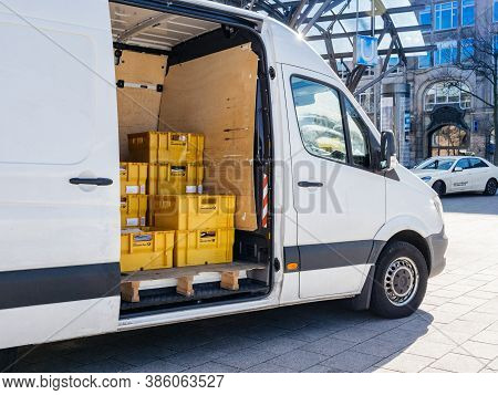 Hamburg, Germany - 20 Mar 2020: White Mercedes-benz Sprinter Parcel Delivery Van With Yellow Boxes W