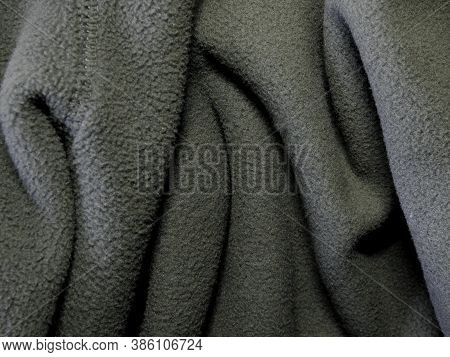 Blanket Made Of Fluffy Fleece Fabric. Background Made Of Soft Plush Fleece Material With Lots Of Rai