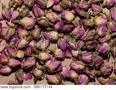 A Lot Of Tea From Dried Buds And Petals Of A Lilac Damask Rose Lies On A Paper Background