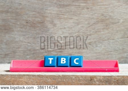 Tile Letter On Red Rack In Word Tbc (abbreviation Of To Be Confirmed Or Continued) On Wood Backgroun
