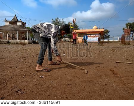 District Katni, India - January 01, 2020: Indian Village Local Boy Playing Gilli Danda, Holded Stick