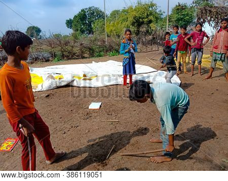 District Katni, India - January 01, 2020: Asian Poor Village Children Playing Gilli Danda Together A