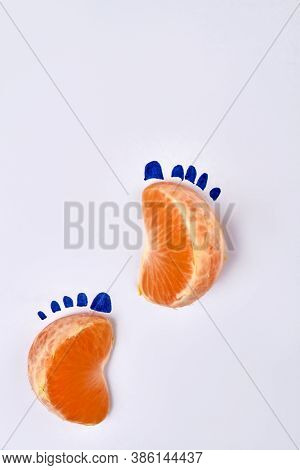 Two Mandaring Slices As Footsteps. Isolated On White Background.